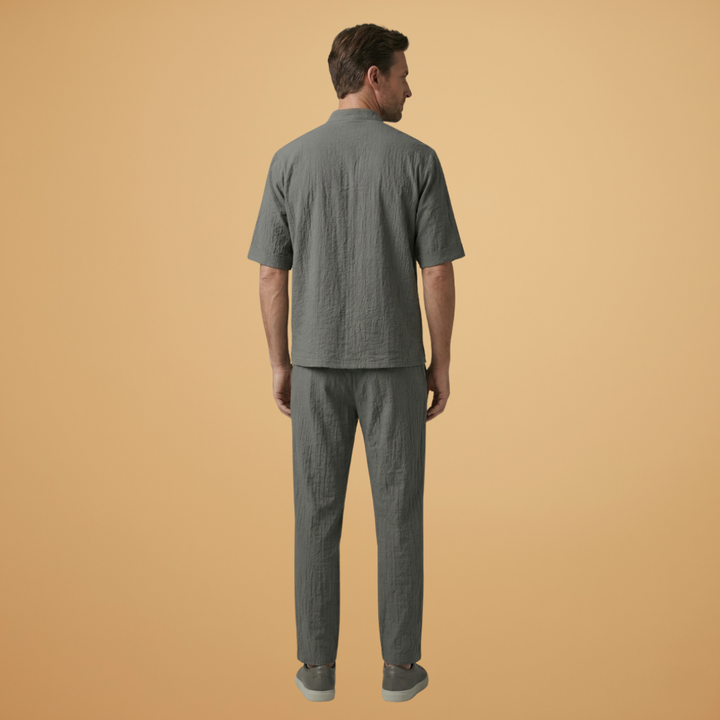 Relaxed fit men's two-piece set with a long sleeve shirt and adjustable drawstring trousers. Versatile style.