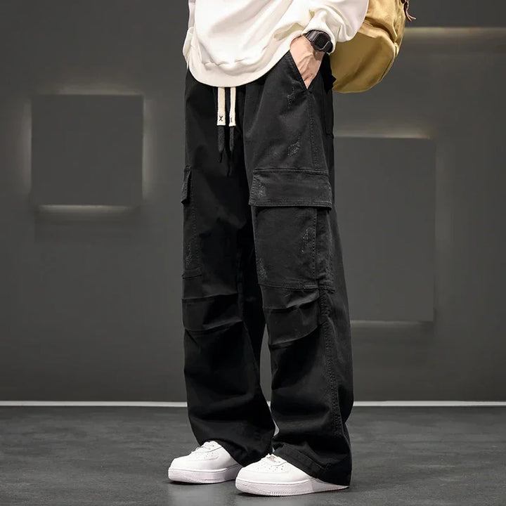 Men's relaxed fit wide leg cargo trousers with drawstring, ideal for casual everyday wear.
