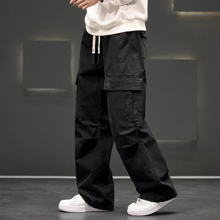 Comfortable men's relaxed fit wide leg cargo pants, perfect for versatile casual and utilitarian style.