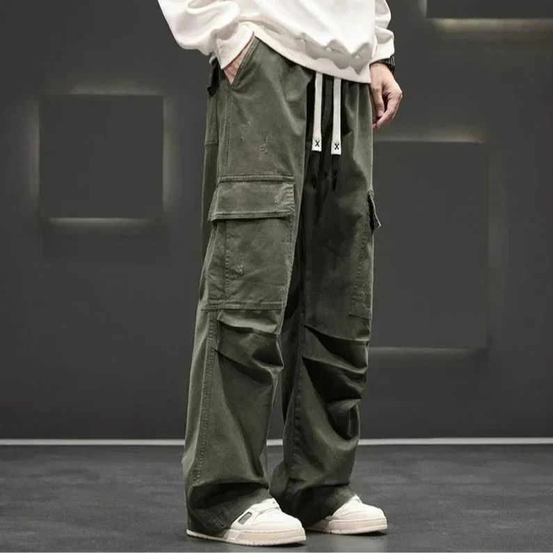 Man in relaxed fit wide leg cargo trousers, demonstrating comfortable casual and versatile fashion.