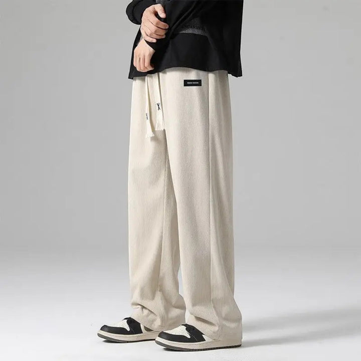 Men's relaxed fit wide leg sweatpants in sand with adjustable drawstring, perfect for casual comfort.