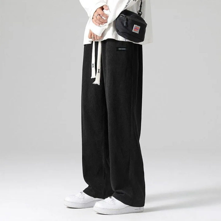 Black men's relaxed fit wide leg sweatpants, ideal for athleisure & everyday stylish comfort with a drawstring.