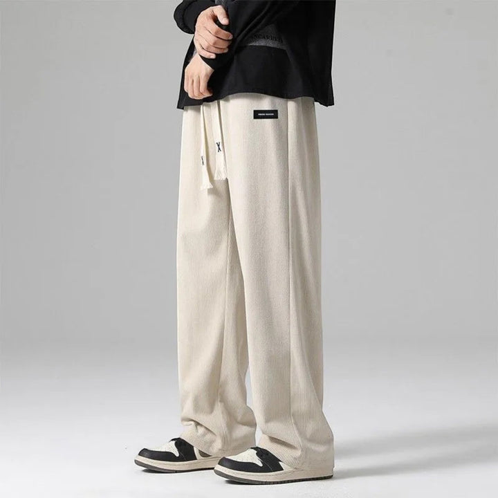 Versatile dark gray men's relaxed fit wide leg sweatpants with drawstring, suitable for loungewear or casual outings.