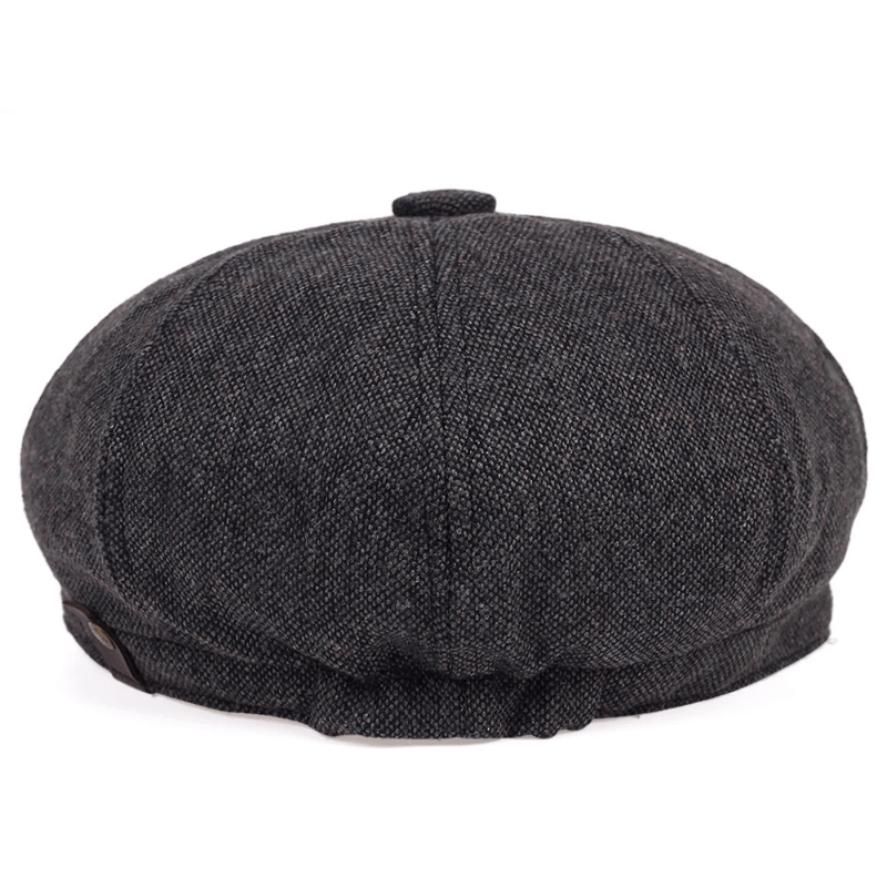 Top-down view of a men's classic herringbone flat cap, emphasizing the elegant vintage pattern.