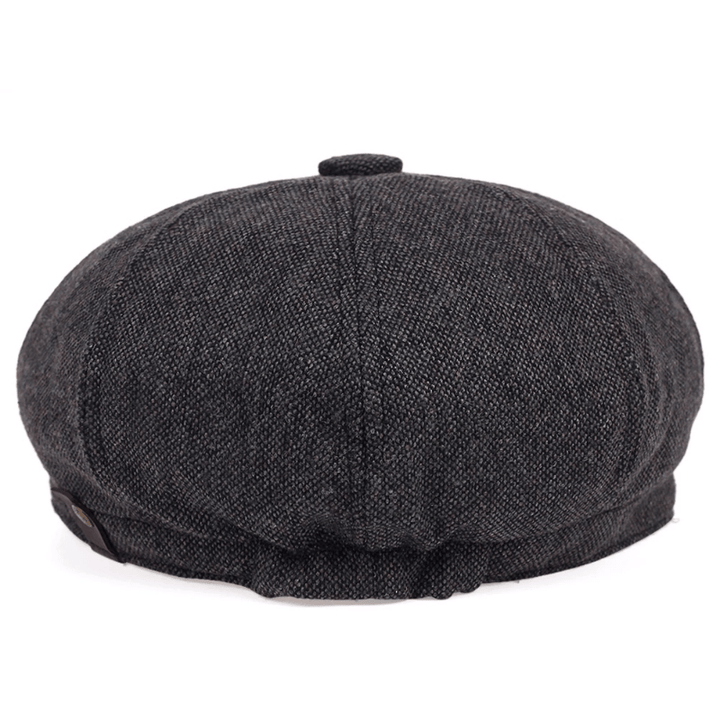 Top-down view of a men's classic herringbone flat cap, emphasizing the elegant vintage pattern.