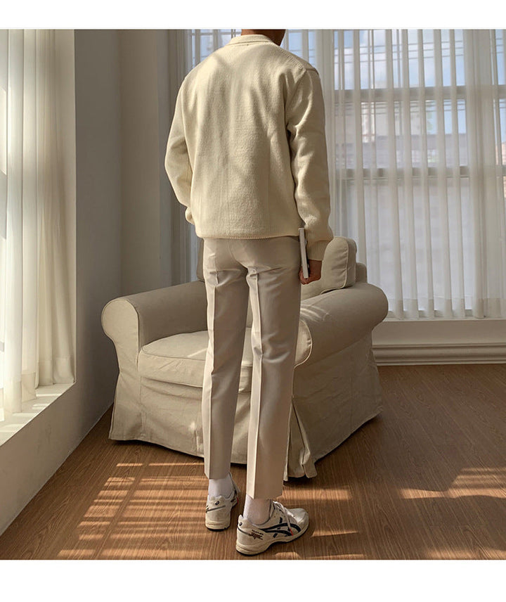Detailed view of a men's ribbed polo knit sweater featuring a classic collar and long sleeves. Smart casual style.