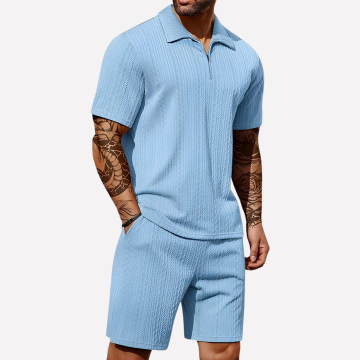 Textured men's ribbed knitwear set with a half-zip polo shirt and matching casual shorts.
