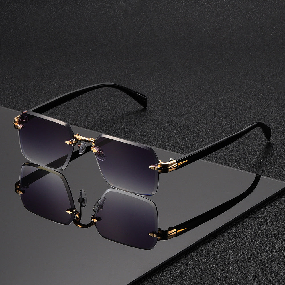Close-up of men's gold rimless square glasses, highlighting craftsmanship.