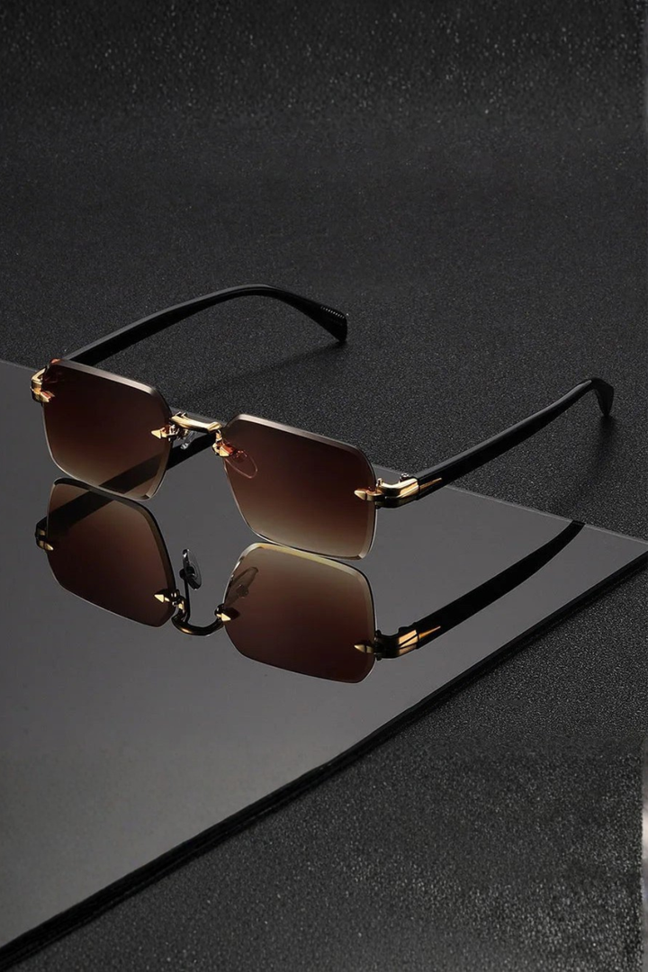 Versatile men's accessory: rimless sunglasses with a chic gold bridge & gradient lenses.