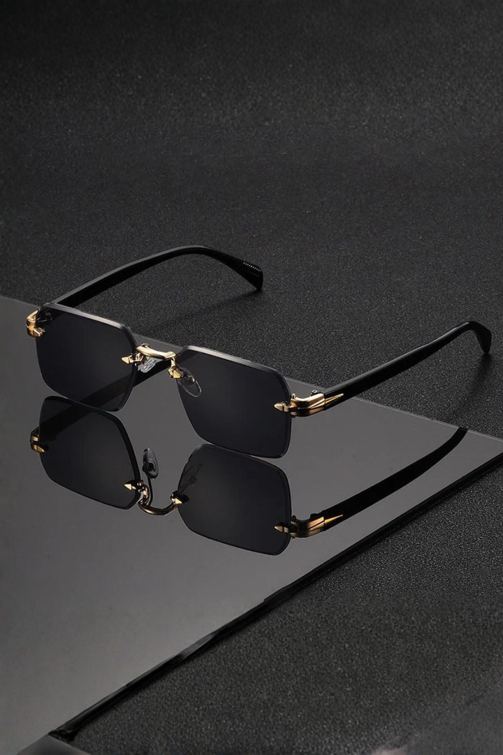Elegant men's rimless sunglasses with a distinctive gold bridge & smooth gradient lenses.