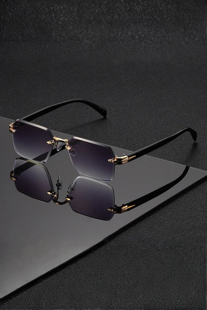 Rimless men's sunglasses. Features a luxurious gold bridge & stylish gradient lenses. Modern eyewear.
