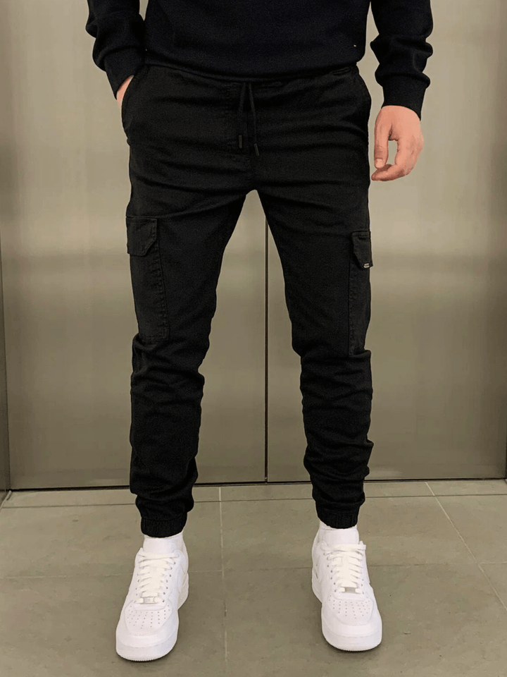 Men's sleek tie-waist cargo trousers in black, perfect for casual or utility wear. Relaxed fit and comfortable.
