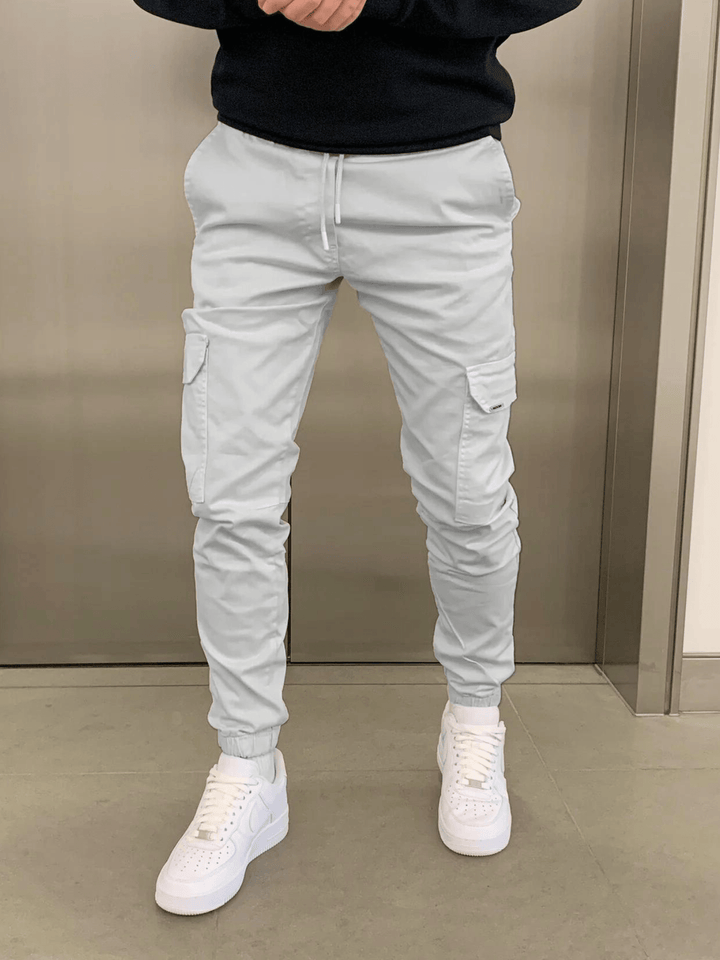Stylish men's tie-waist cargo trousers in a dark color, perfect for a relaxed yet fashionable look.