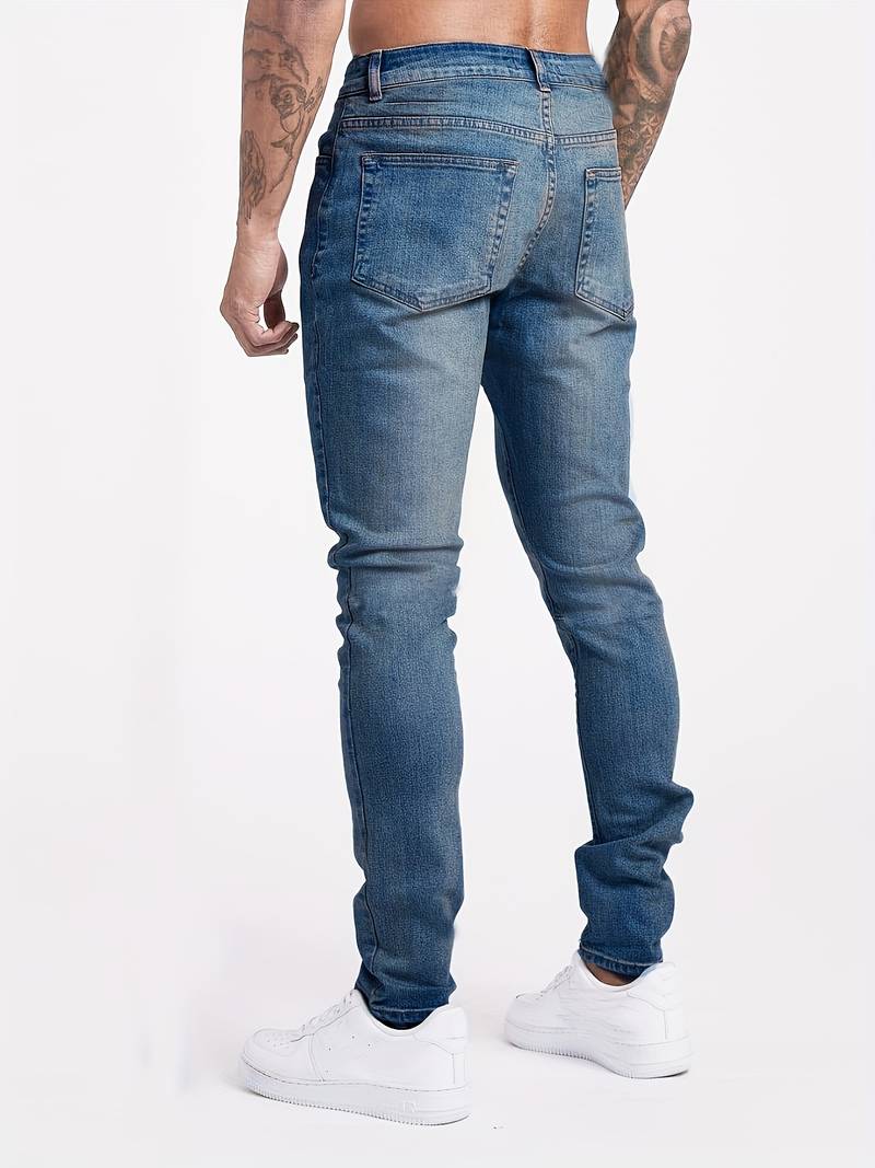 Back view of men's slim fit blue denim jeans, highlighting modern streetwear look
