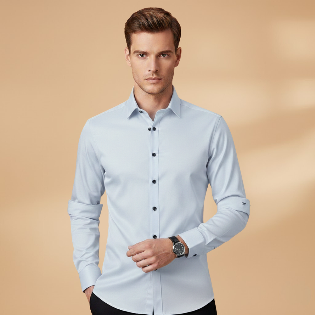 A man confidently wearing a slim-fit button-down shirt for business casual.