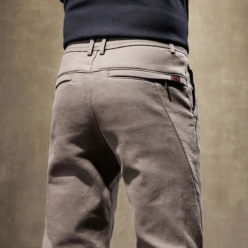 Close-up of comfortable, modern men's slim-fit casual pants fabric, showing quality & texture.