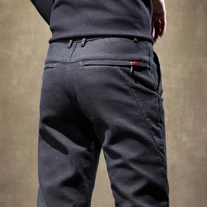 Collection of men's slim-fit casual pants in khaki, grey & black, showcasing versatile modern comfort.