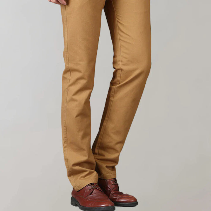Close-up of men's slim fit chinos fabric, highlighting quality & modern style. Perfect casual pants for versatile wear.