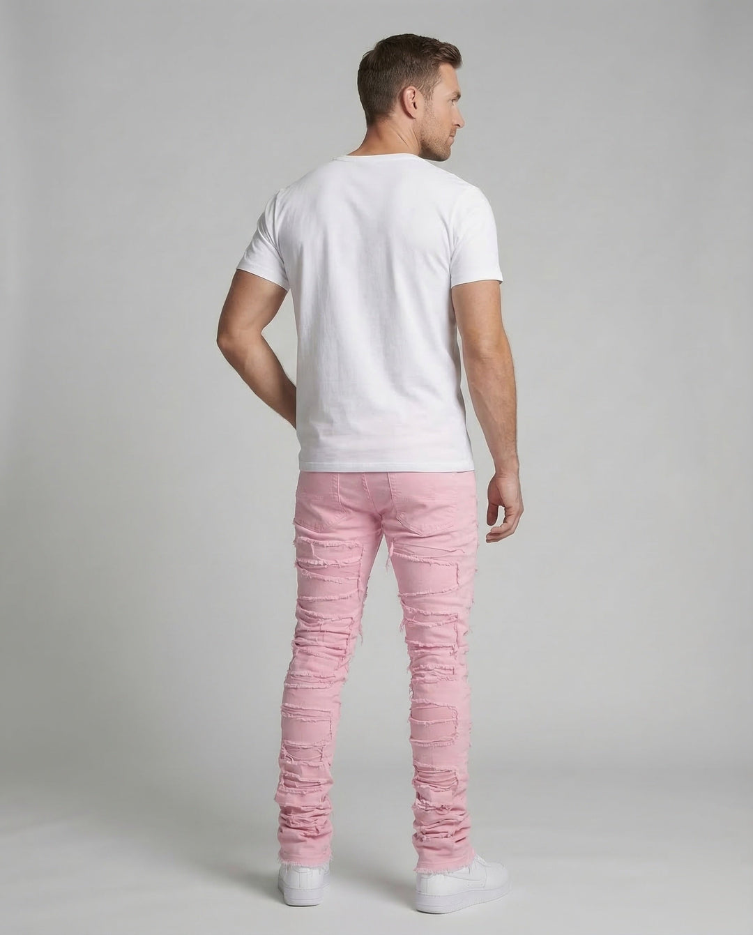 Model wearing men's distressed denim jeans, slim fit, ideal for contemporary urban style.