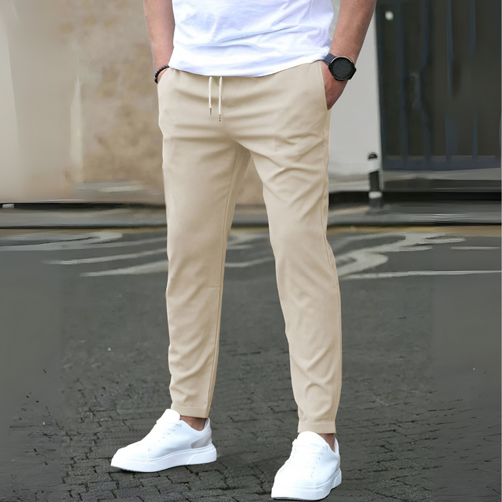 Comfortable men's slim fit casual pants with adjustable drawstring, shown in grey.