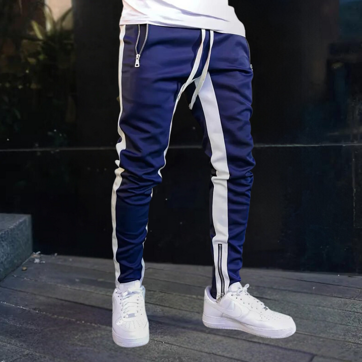Stylish men's slim fit activewear joggers featuring cool contrast panels and functional zip cuffs, perfect for streetwear.