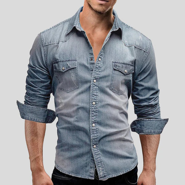 Men's slim fit light blue long sleeve denim overshirt with button-up closure.