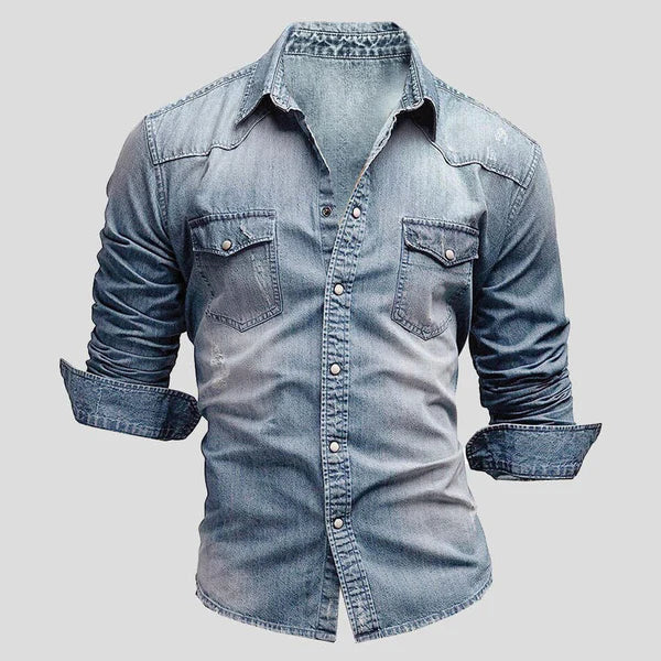 Close-up of a men's long sleeve denim shirt showing fabric texture and button details.