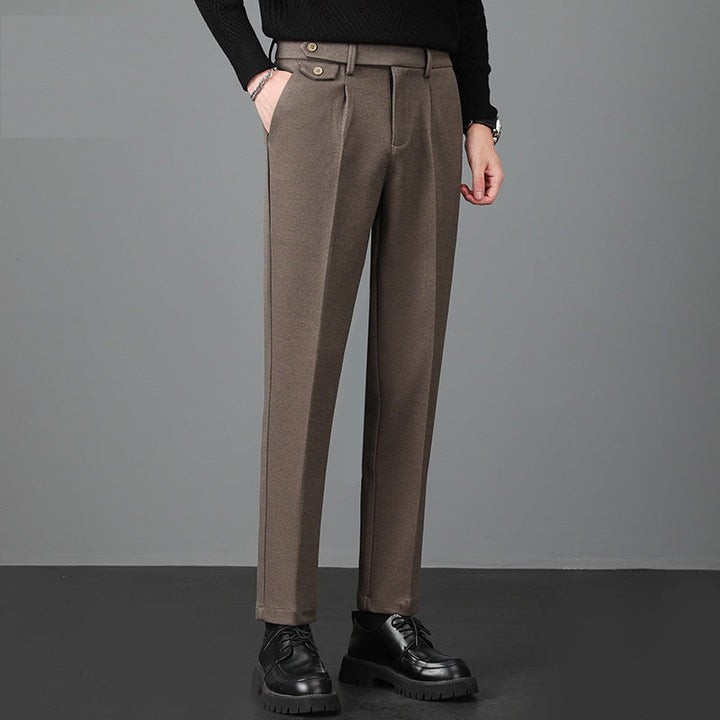 Close-up of men's tailored slim fit dress pants fabric, showing sophisticated texture suitable for office wear.