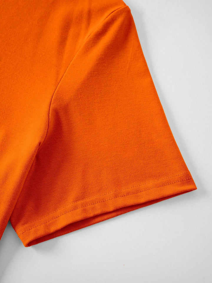 New men's slim-fit orange t-shirt with festive King's Day graphic. Perfect spring/summer celebration wear and casual top.