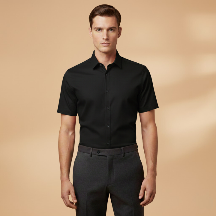 Model posing in a casual setting with a black men's fitted short sleeve button-down shirt.