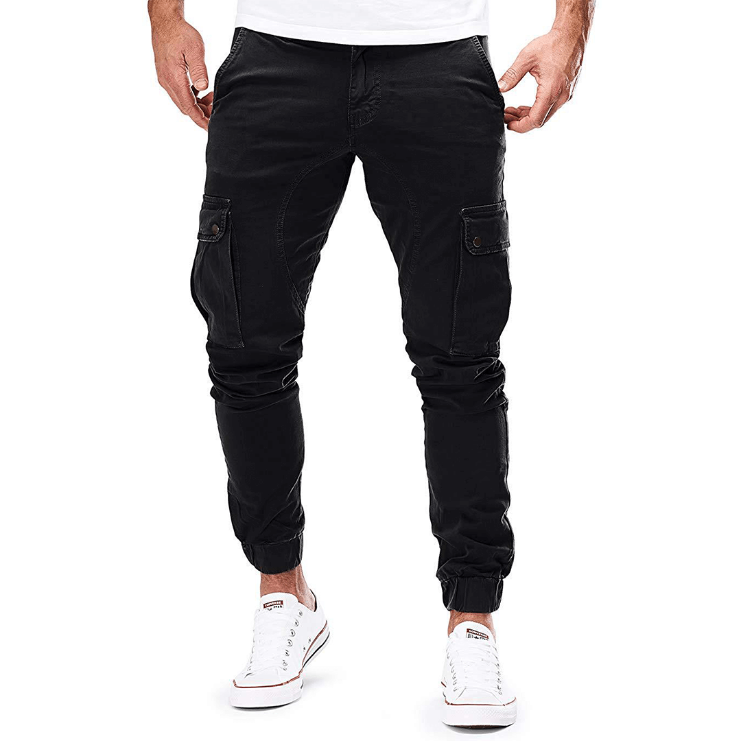 Man wearing dark grey slim fit stretch cargo trousers, showcasing comfort and practical multi-pocket design.