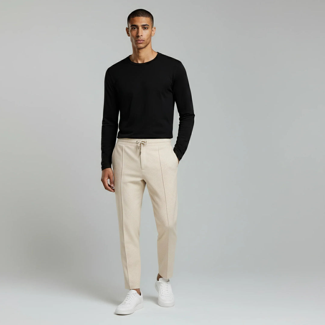 Men's slim fit textured drawstring trousers in a casual setting for everyday wear.