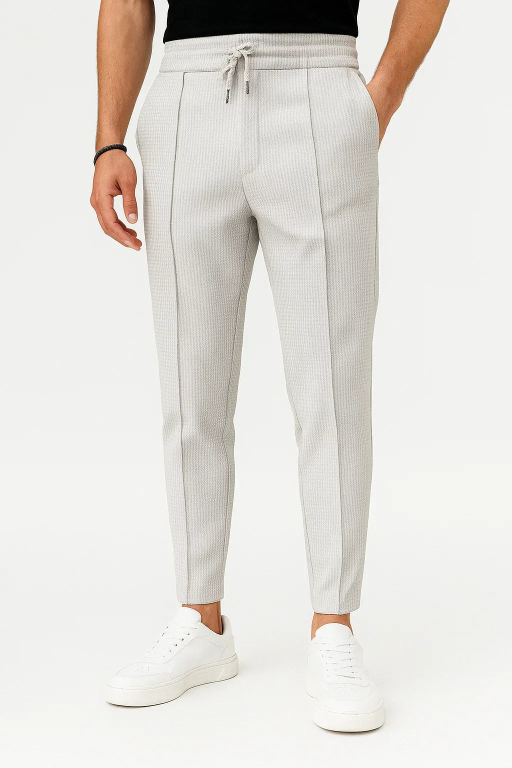 Close-up of the textured fabric on men's slim fit drawstring trousers, perfect for casual style.