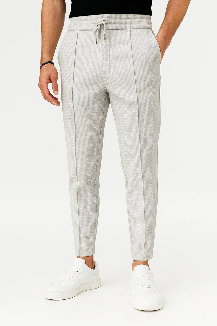 Close-up of the textured fabric on men's slim fit drawstring trousers, perfect for casual style.
