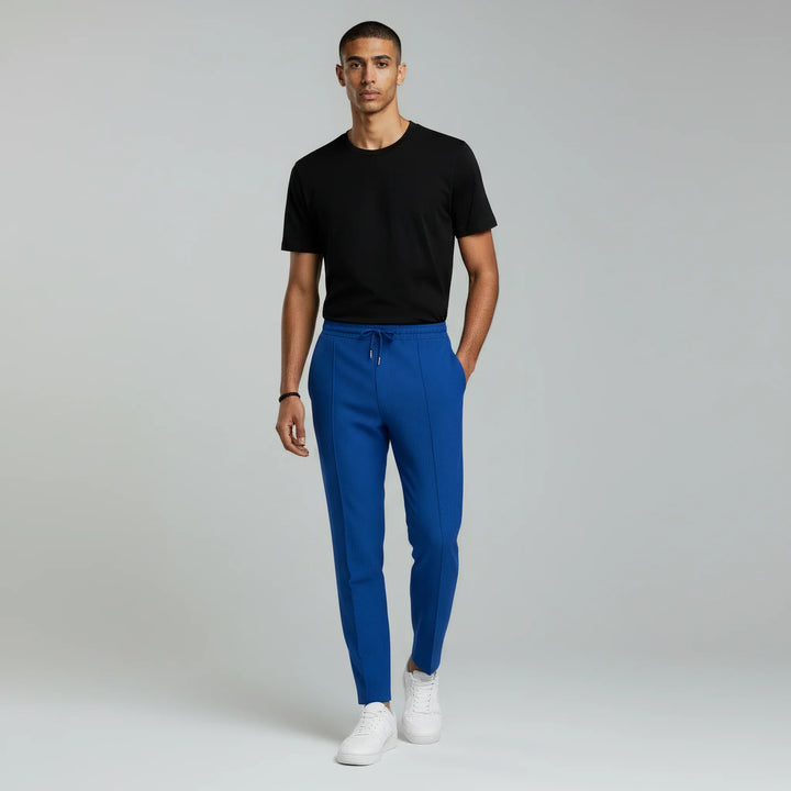 Stylish men's slim fit drawstring pants with a subtle textured finish, versatile for daily fashion.