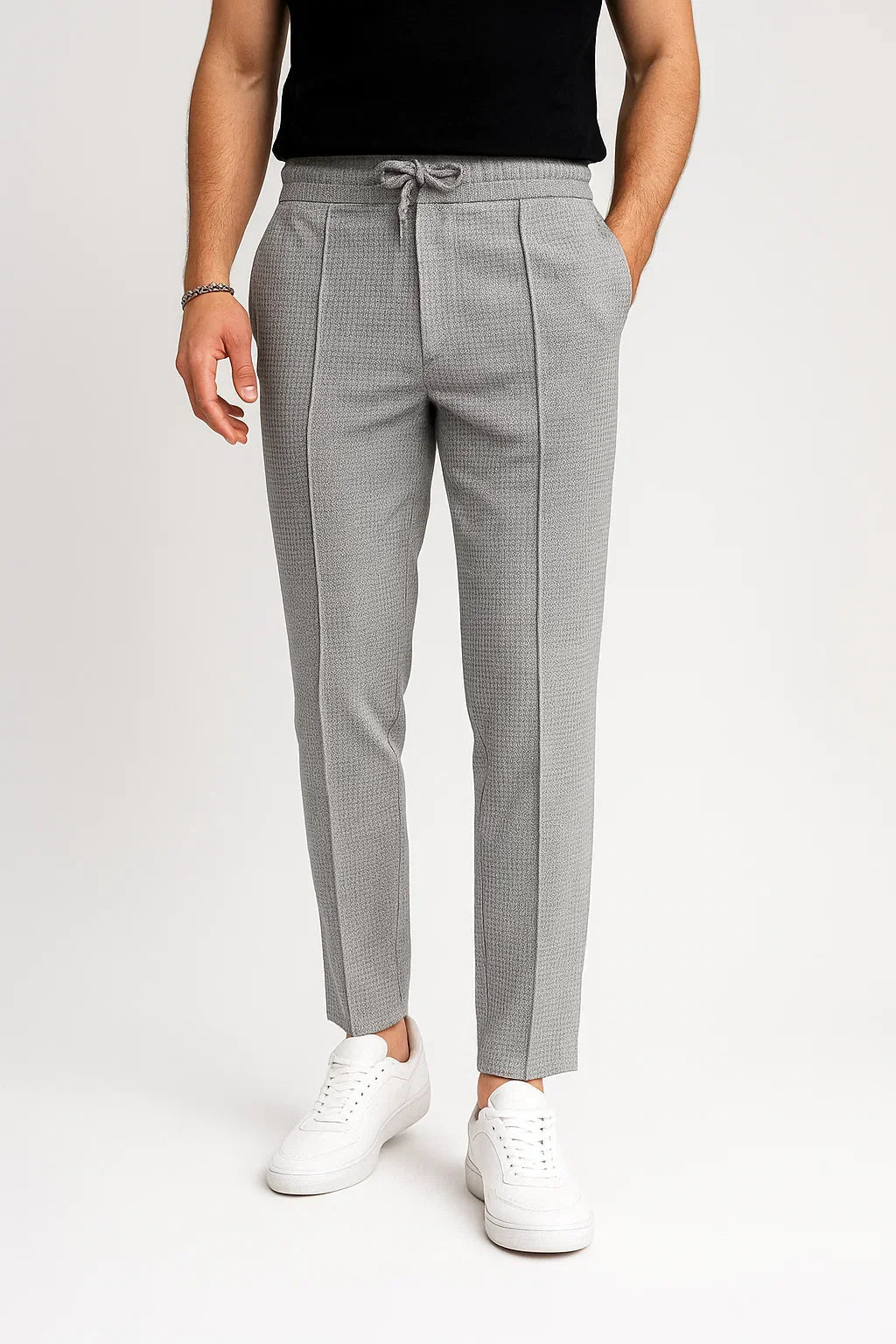 Full-length view of men's slim fit textured drawstring trousers, a key piece for men's fashion.