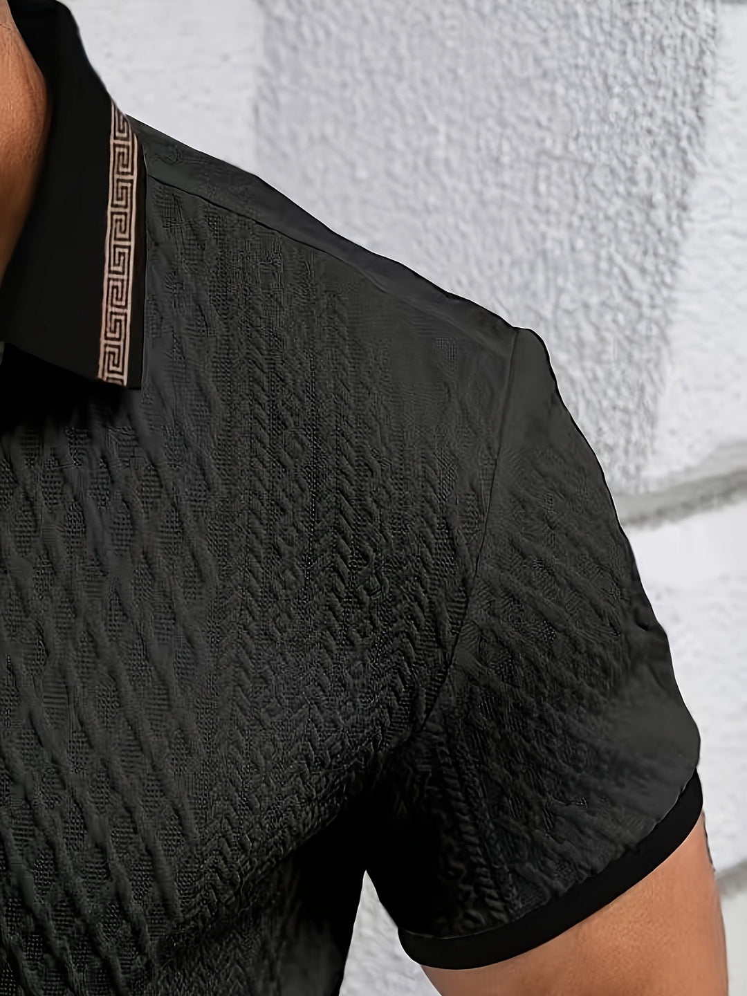 Close-up of the breathable textured fabric on a men's short sleeve polo shirt.