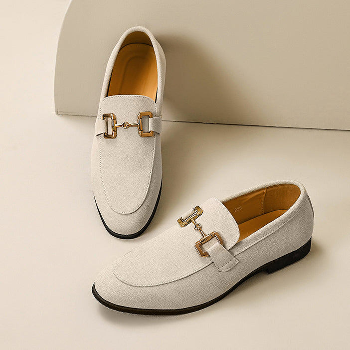 Front view of men's slip-on loafers showcasing the refined metal embellishment