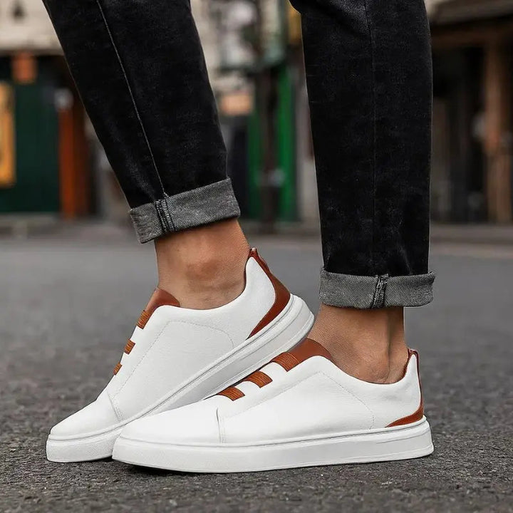 Modern men's slip-on sneakers, versatile for casual wear & athletic activity, featuring secure loop lacing.