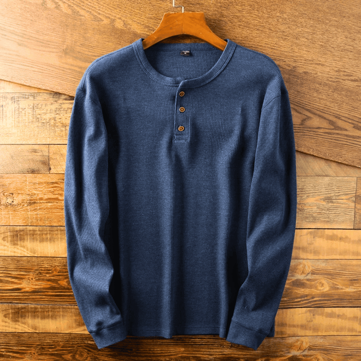 Close-up of a soft men's Henley shirt with detailed button-up neckline. Everyday casual top.