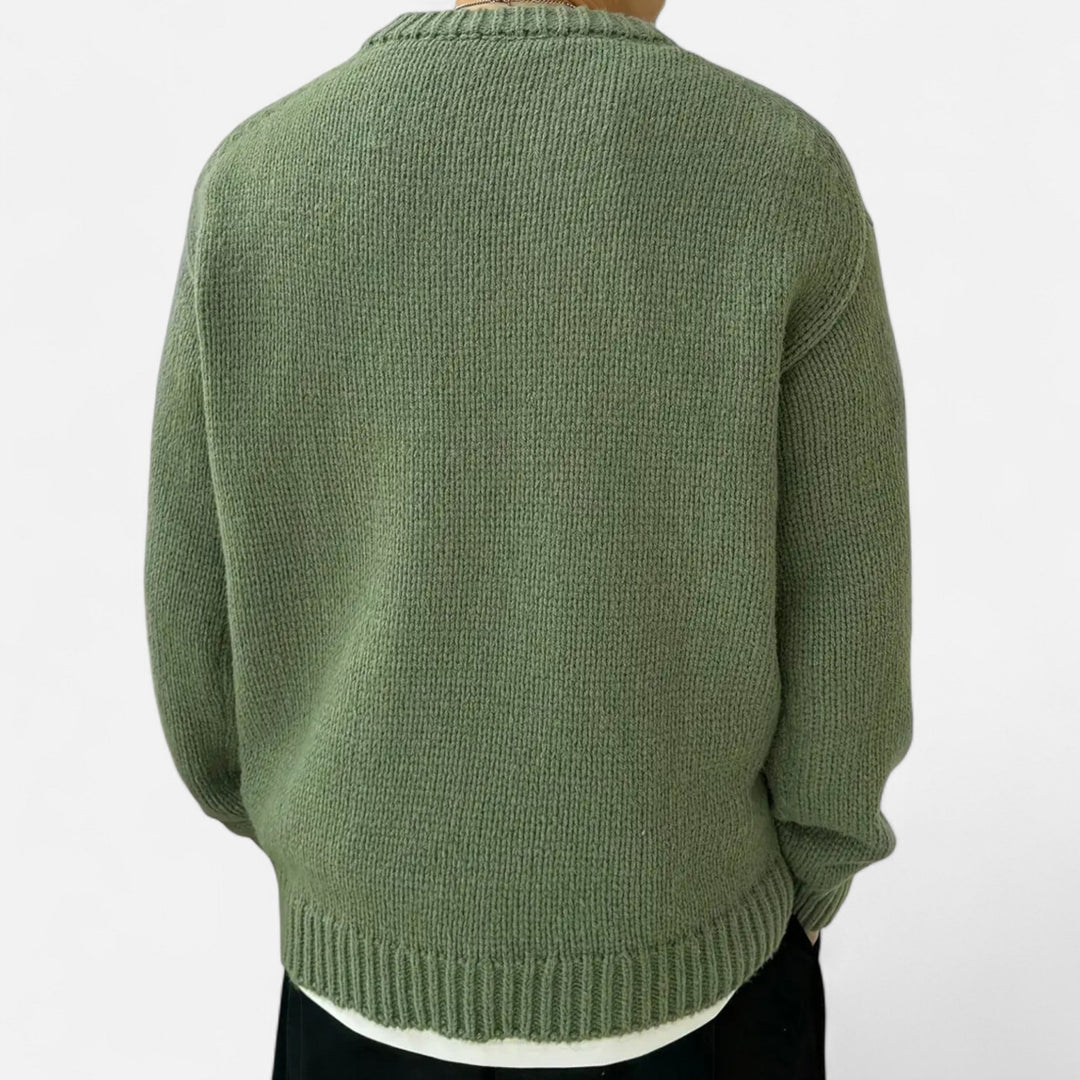Men's solid knit sweater, featuring a crew neck and long sleeves.