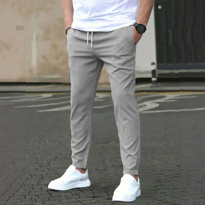 Men's sporty joggers with practical pockets & comfortable elastic waistband, ideal for active wear.