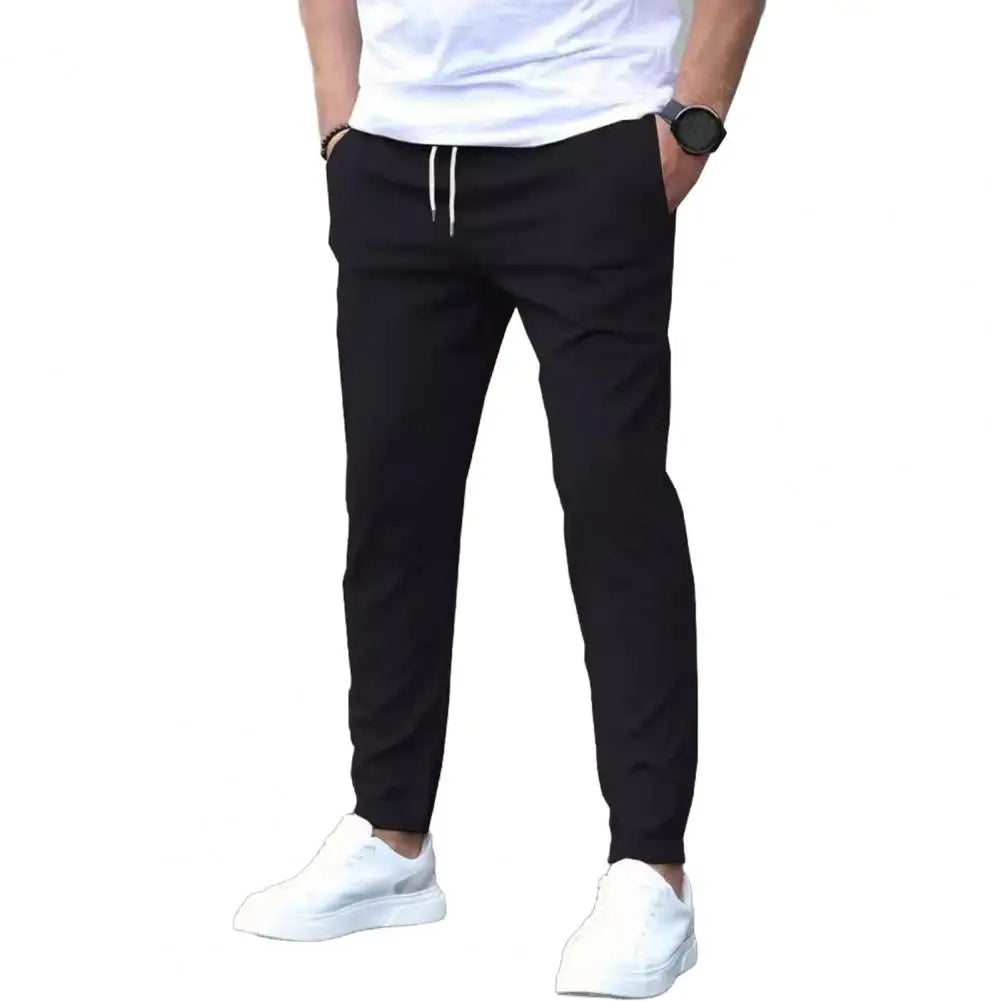 Full shot of men's sporty joggers, showcasing the elastic waistband, secure pockets, and athletic fit.