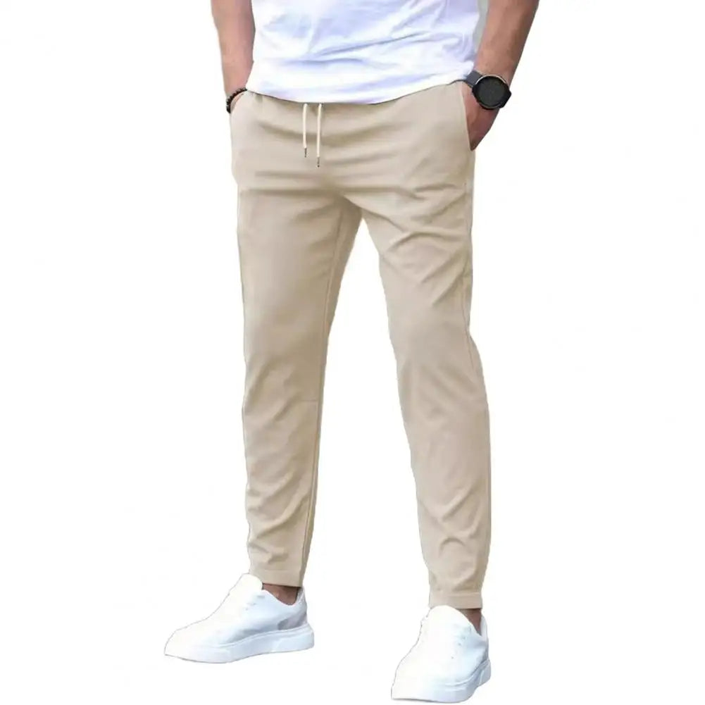 Men's workout bottoms: durable polyester joggers with a flexible elastic waistband & essential pockets for training.
