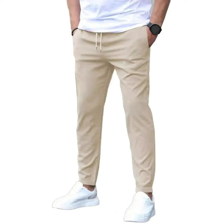 Men's workout bottoms: durable polyester joggers with a flexible elastic waistband & essential pockets for training.