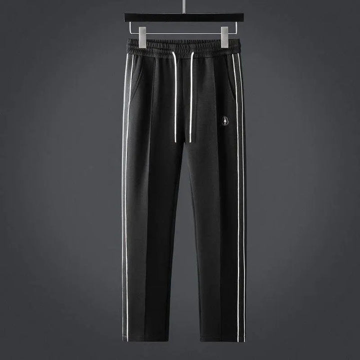 Soft men's two-piece tracksuit set: zip-up jacket & joggers. Stylish activewear and loungewear for ultimate comfort.