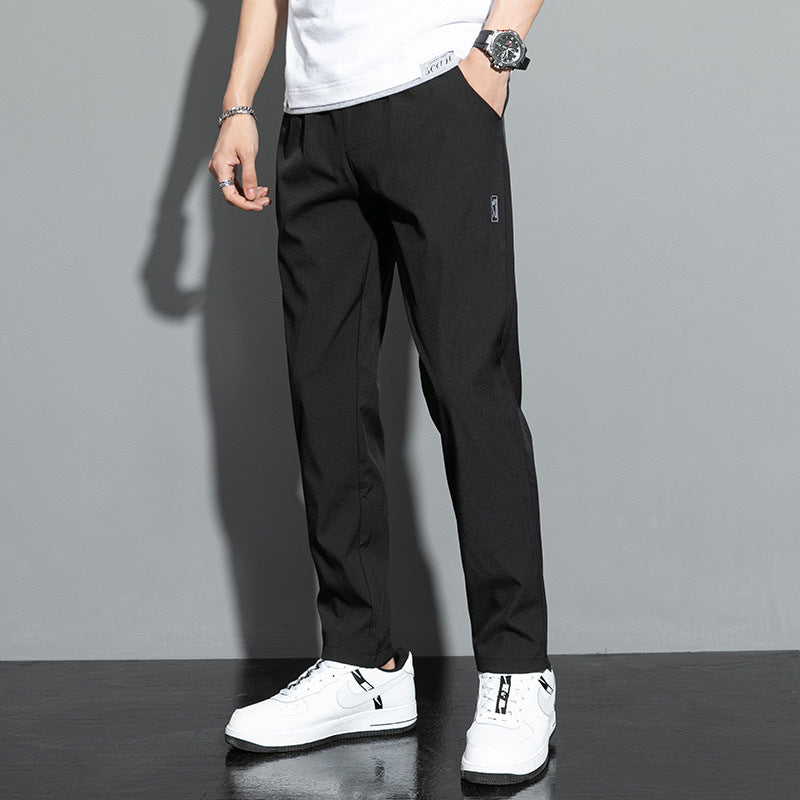 Men's straight leg comfort pants with elastic waist & practical slash pockets, ideal for casual or office wear.