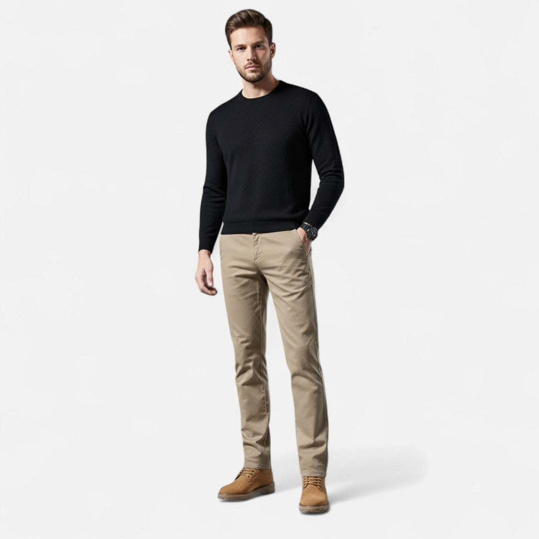 Close-up of the fine stitching on men's tailored straight-leg cotton trousers.