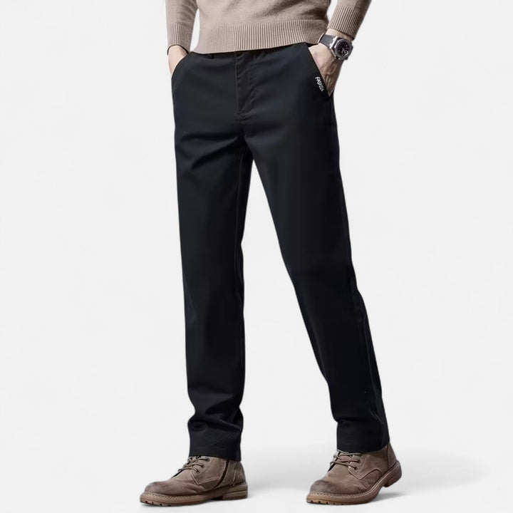 Detailed shot of the waistband and pockets on men's straight-leg tailored pants.