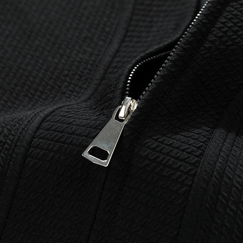 Casual men's wear featuring a full-zip knit sweater.